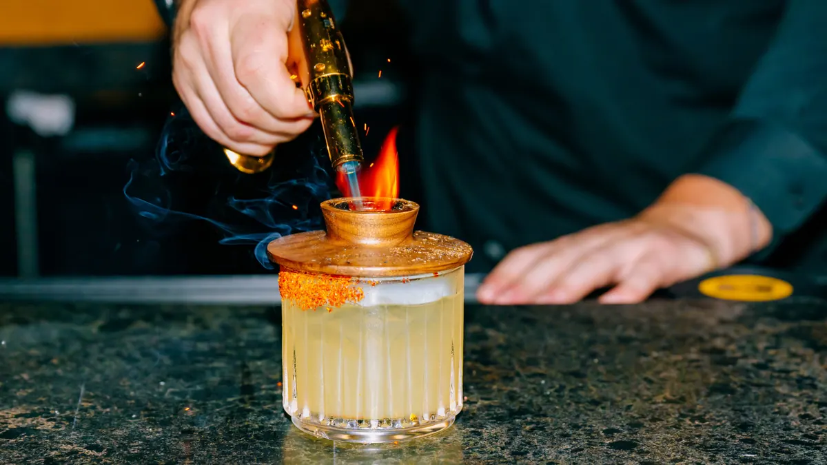 Vinyl Room Las Vegas bartender torching a signature cocktail